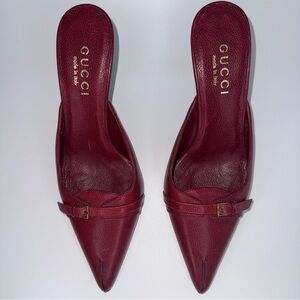 Gucci leather pointed toe mules with small gold-toned buckle detail